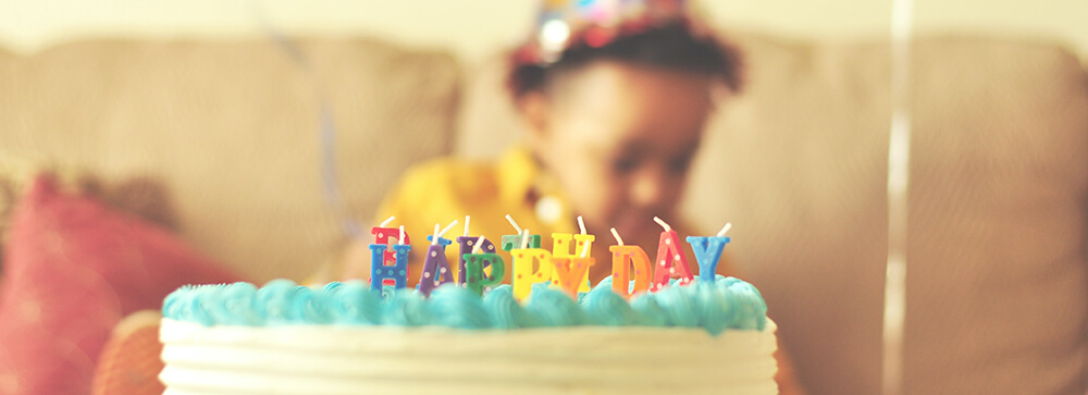 Child with birthday cake and candles